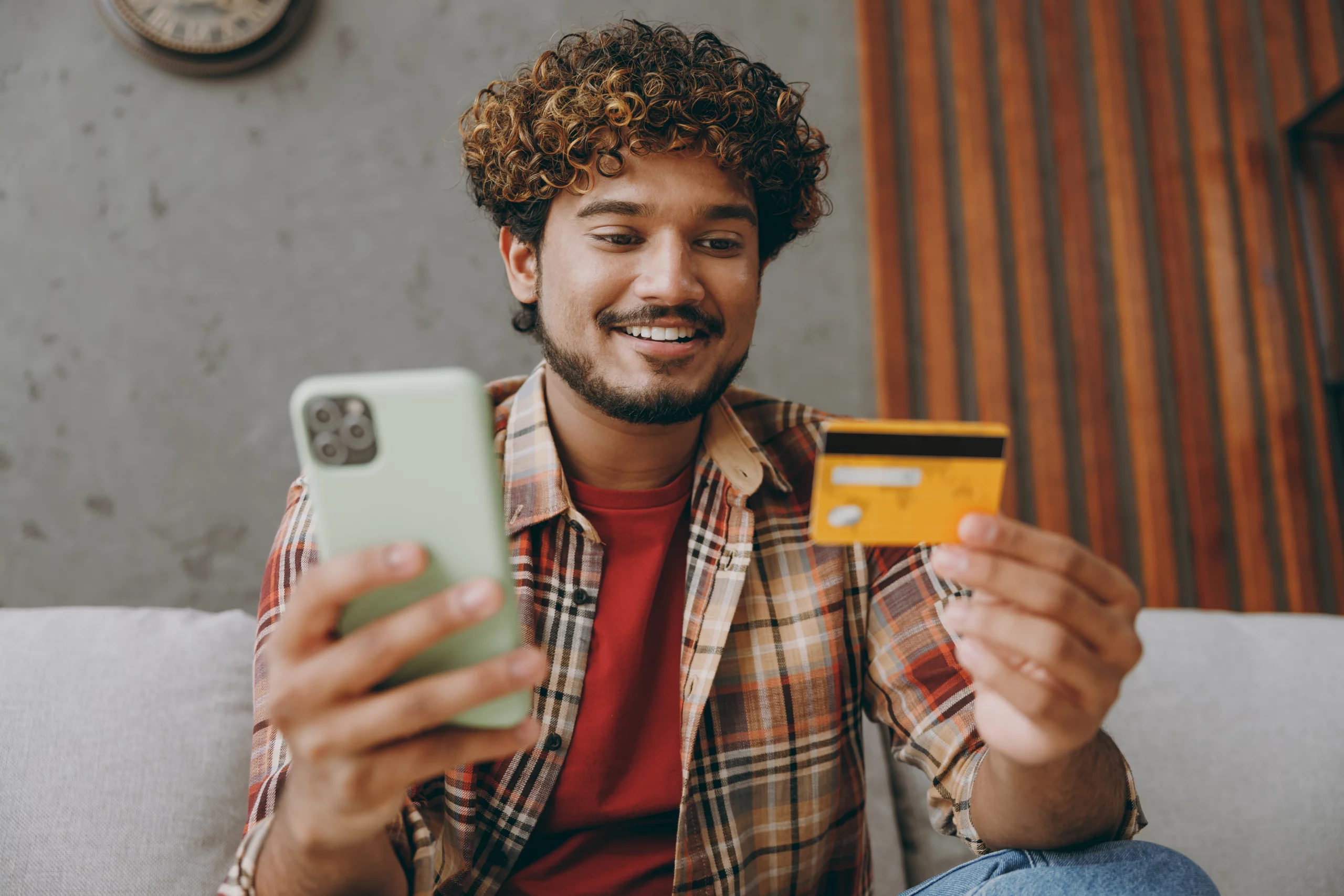 man with phone and credit card; Why Businesses Need Secure Payment Services | Biz Core